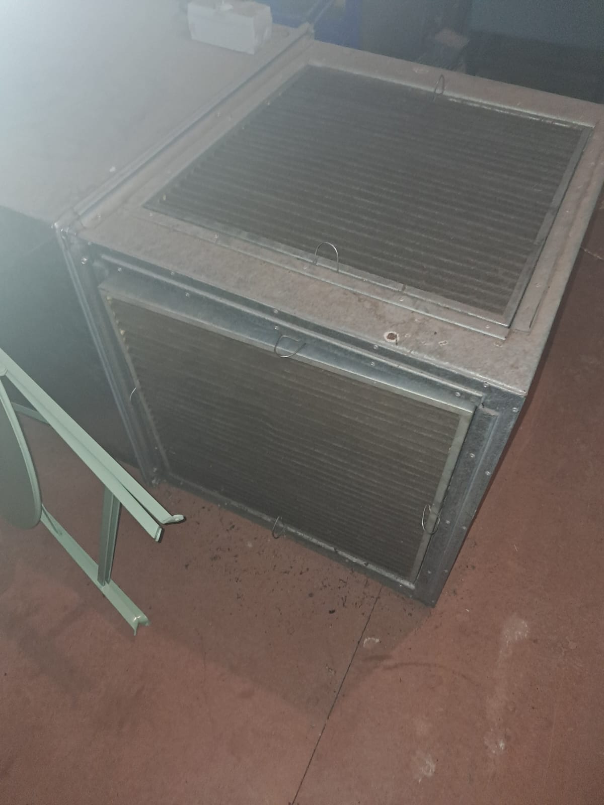 Large ducted air-conditioning indoor coil removed for inspection
