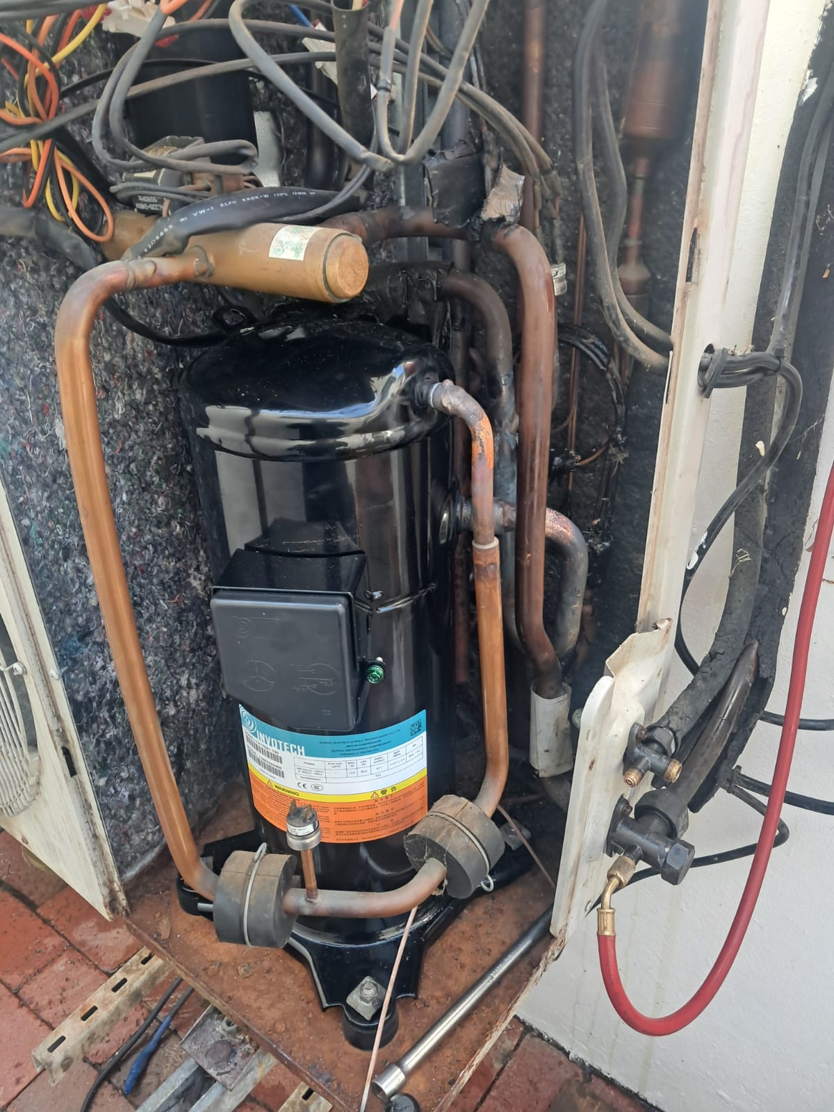 Replacement compressor installed inside a large R22 air-conditioning outdoor unit