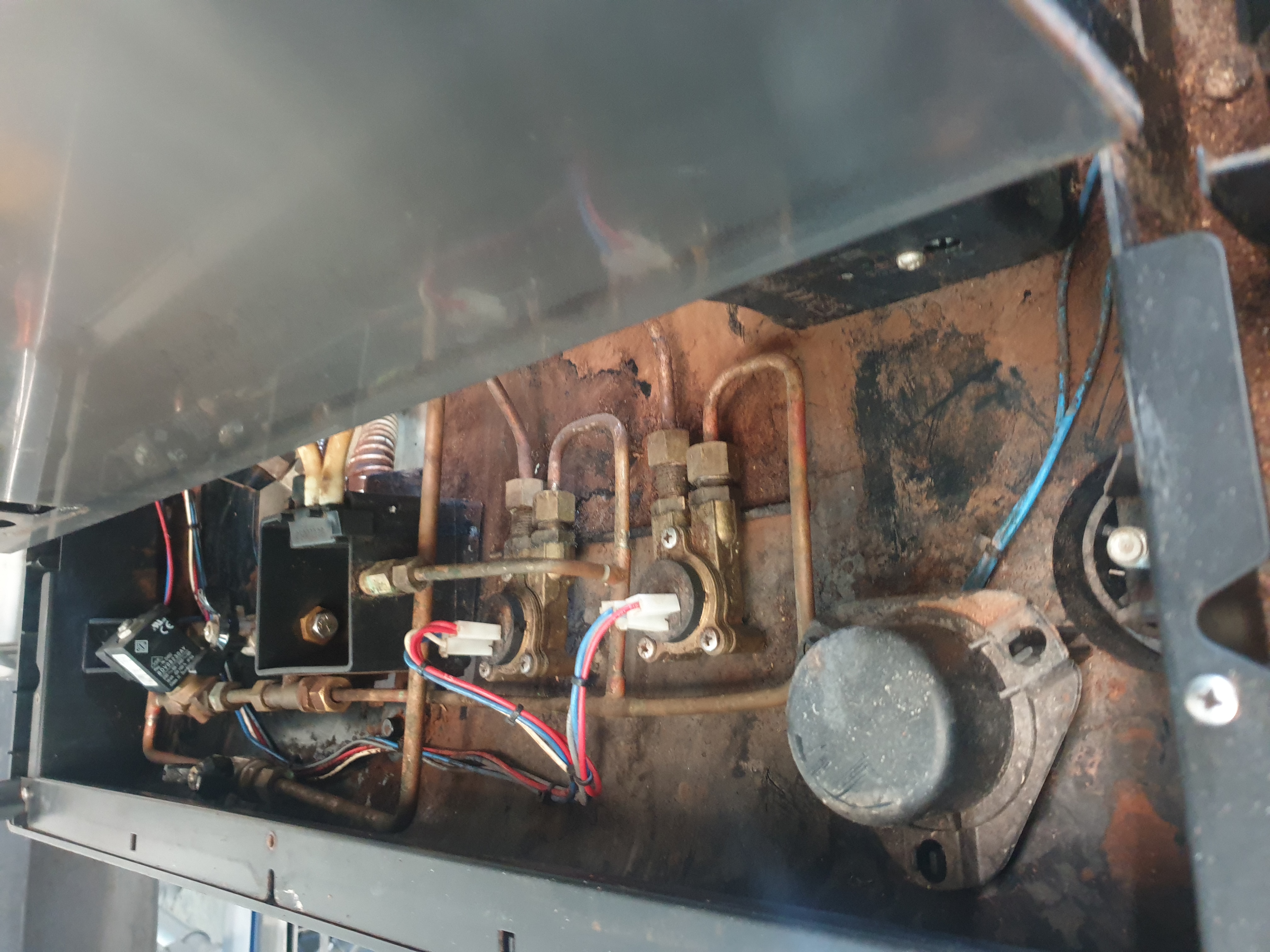Commercial coffee machine internals during solenoid and plumbing checks
