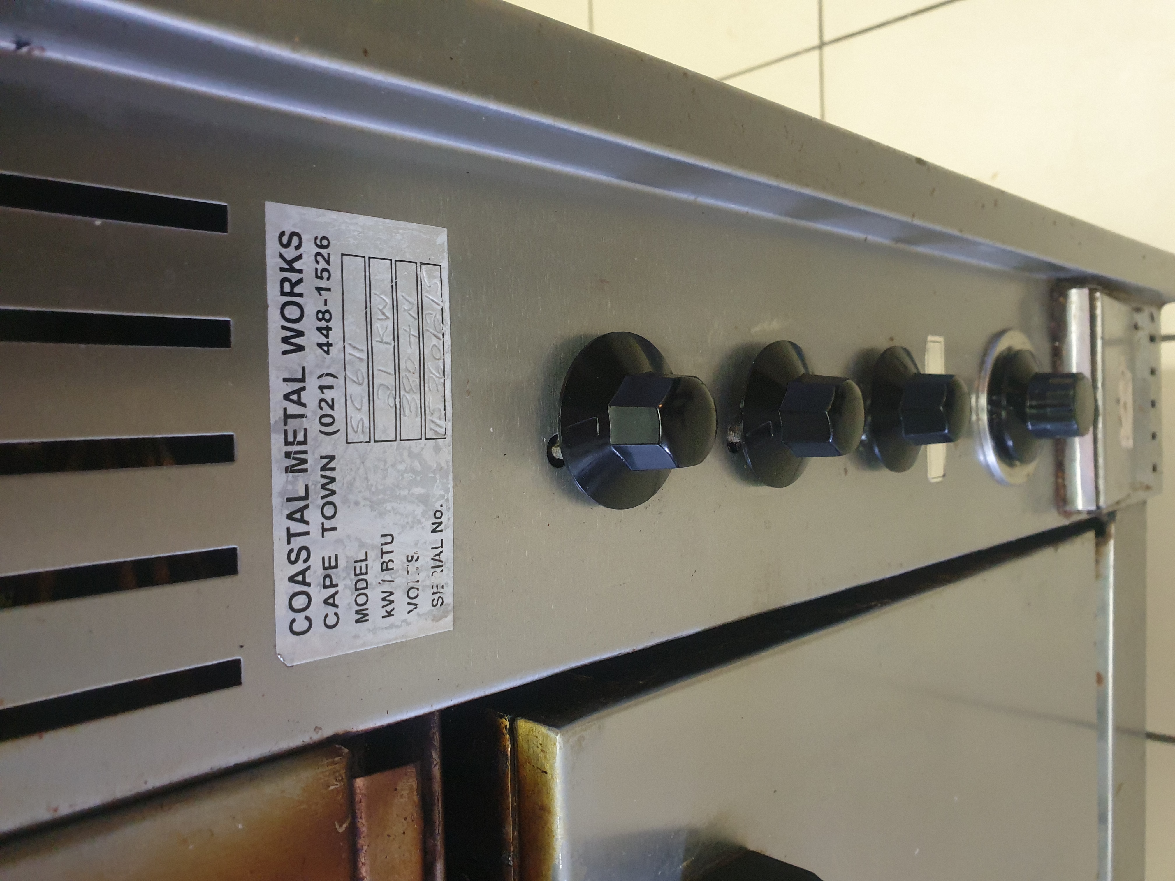 Commercial stove control panel and data plate after inspection