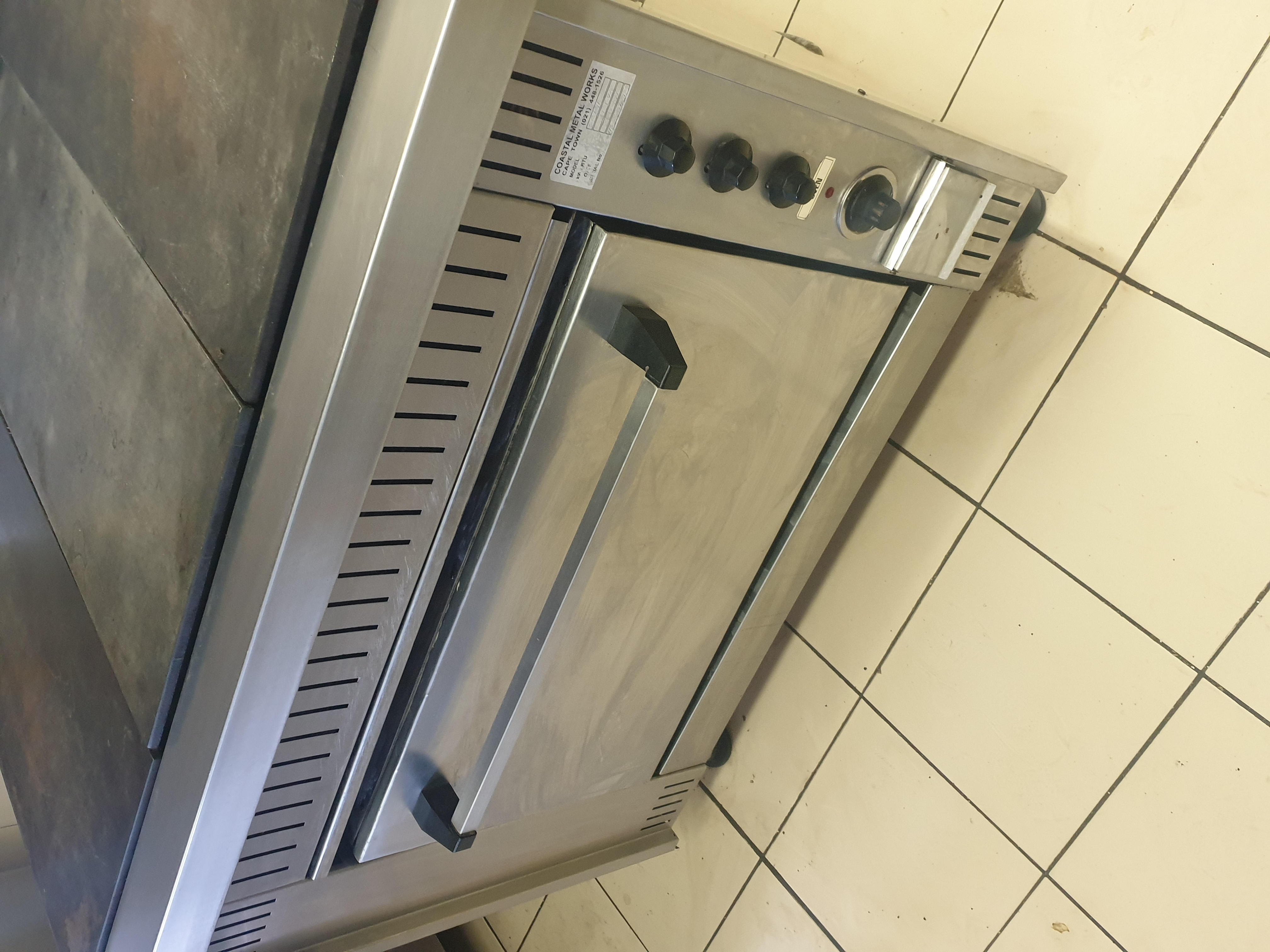 Commercial stove with oven and top grill section after rewiring repair