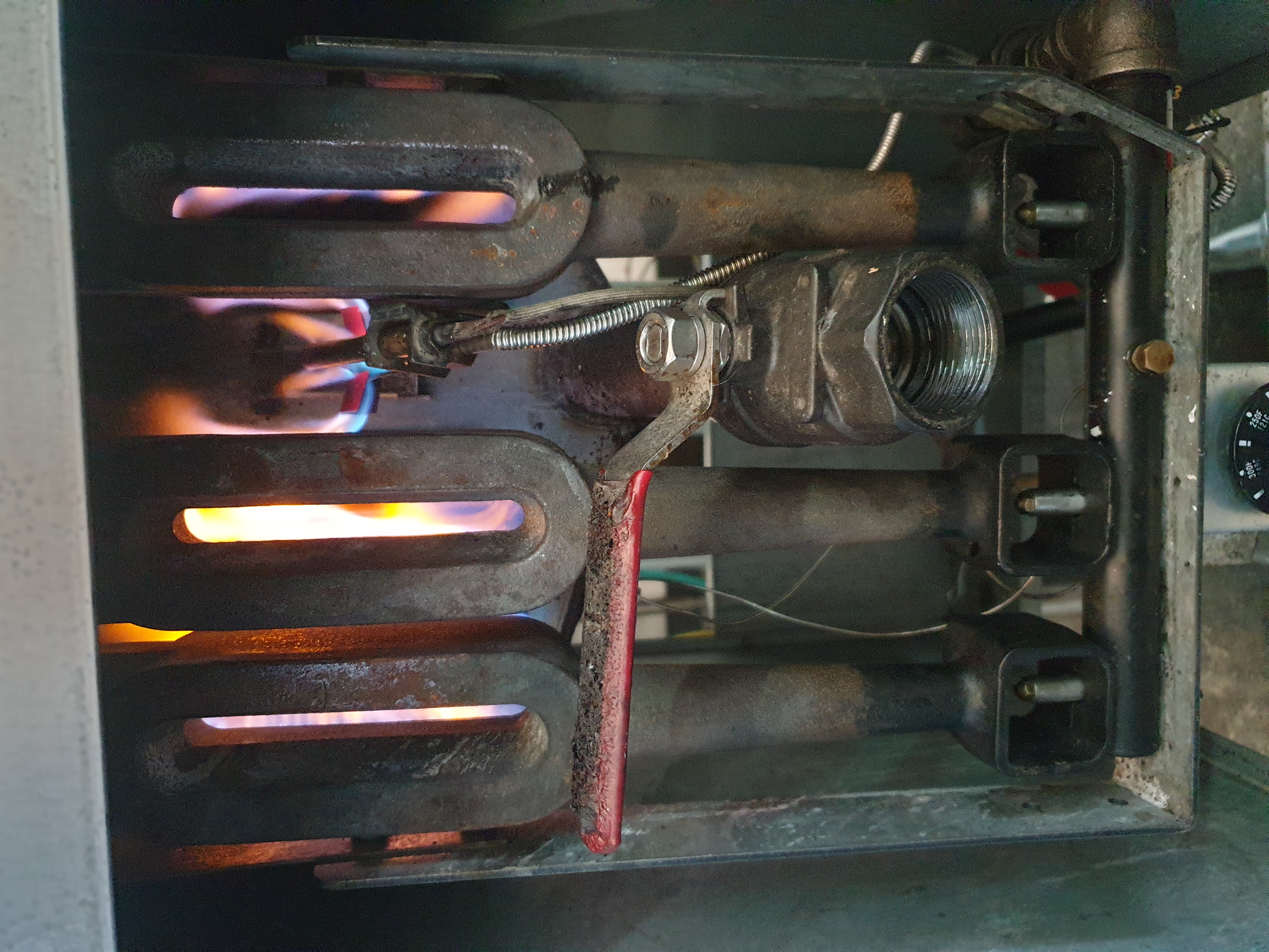 Commercial gas fryer burners operating during flame and pilot safety checks