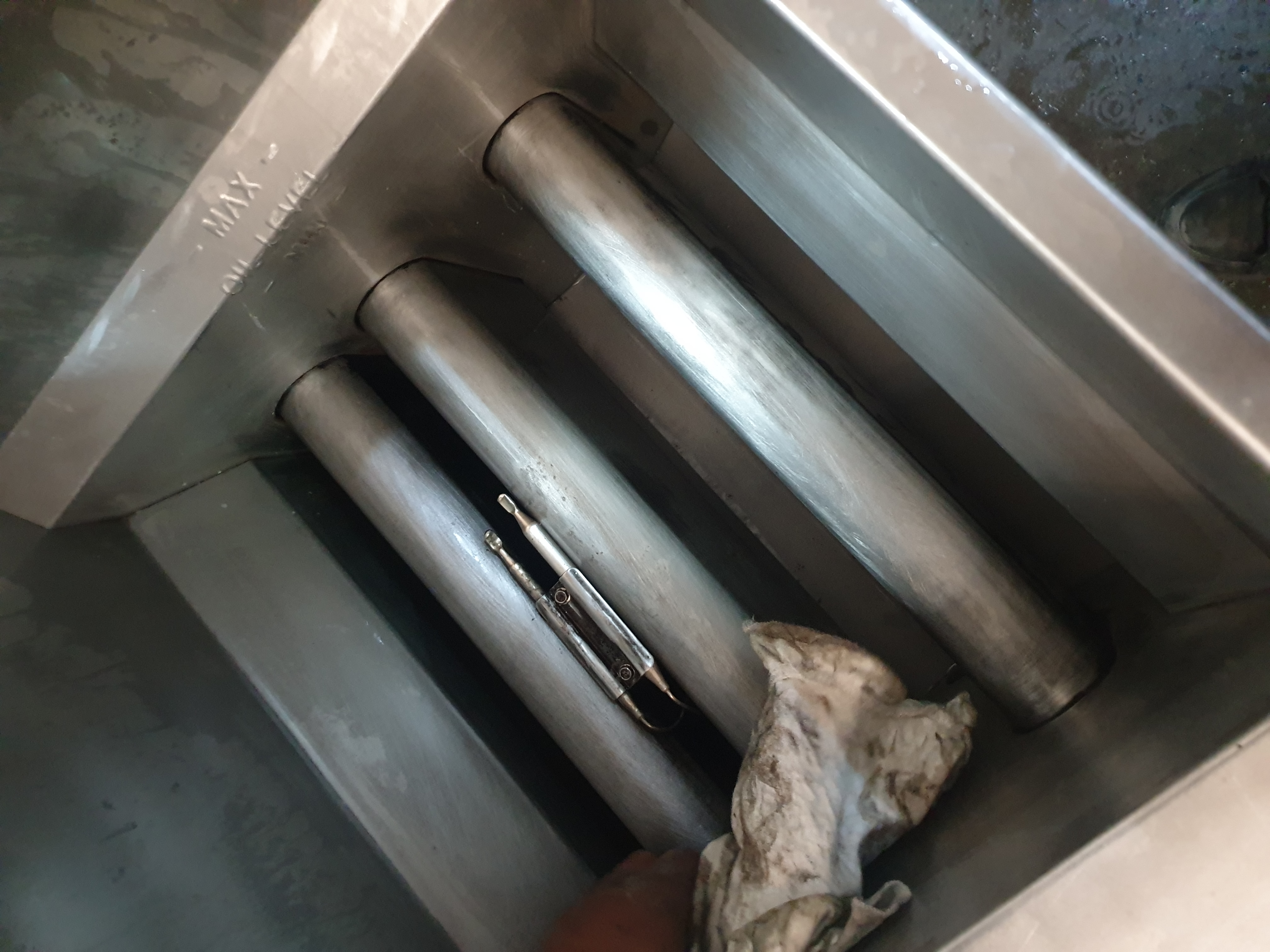 Commercial fryer burner tubes and pilot assembly after cleaning