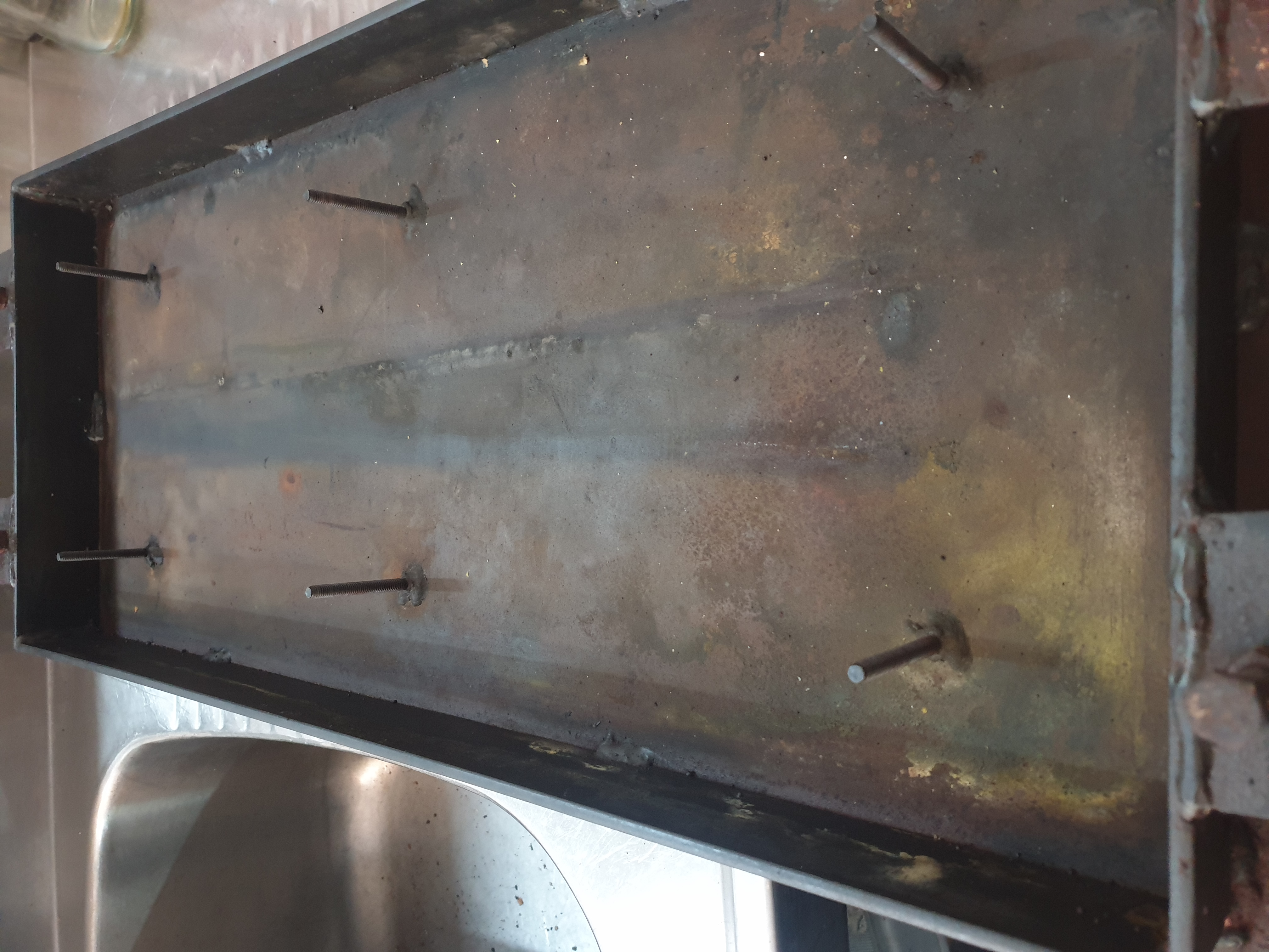 Commercial hotplate underside showing plate and mounting studs