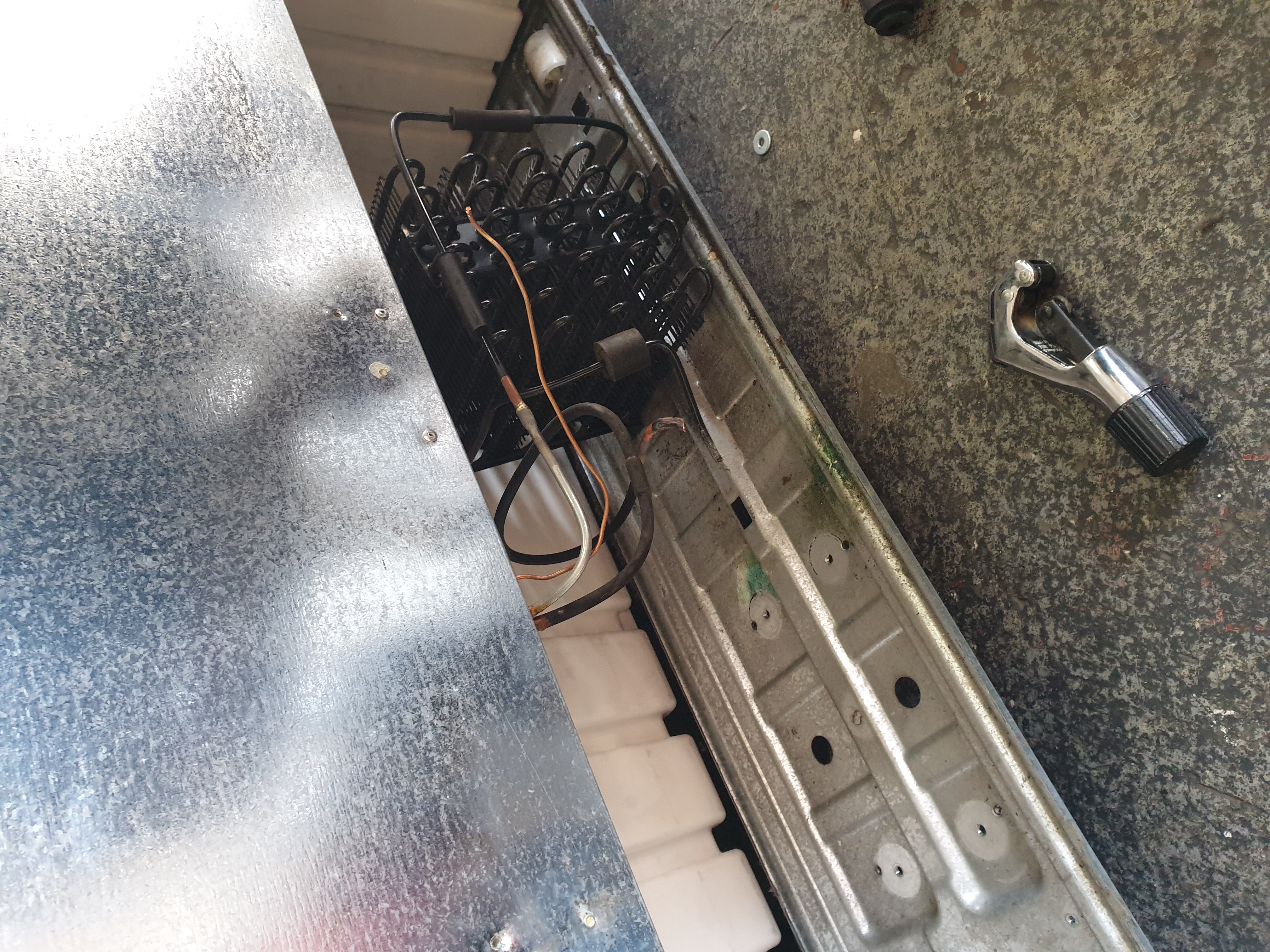 Domestic side-by-side fridge compressor area during removal and pipework preparation