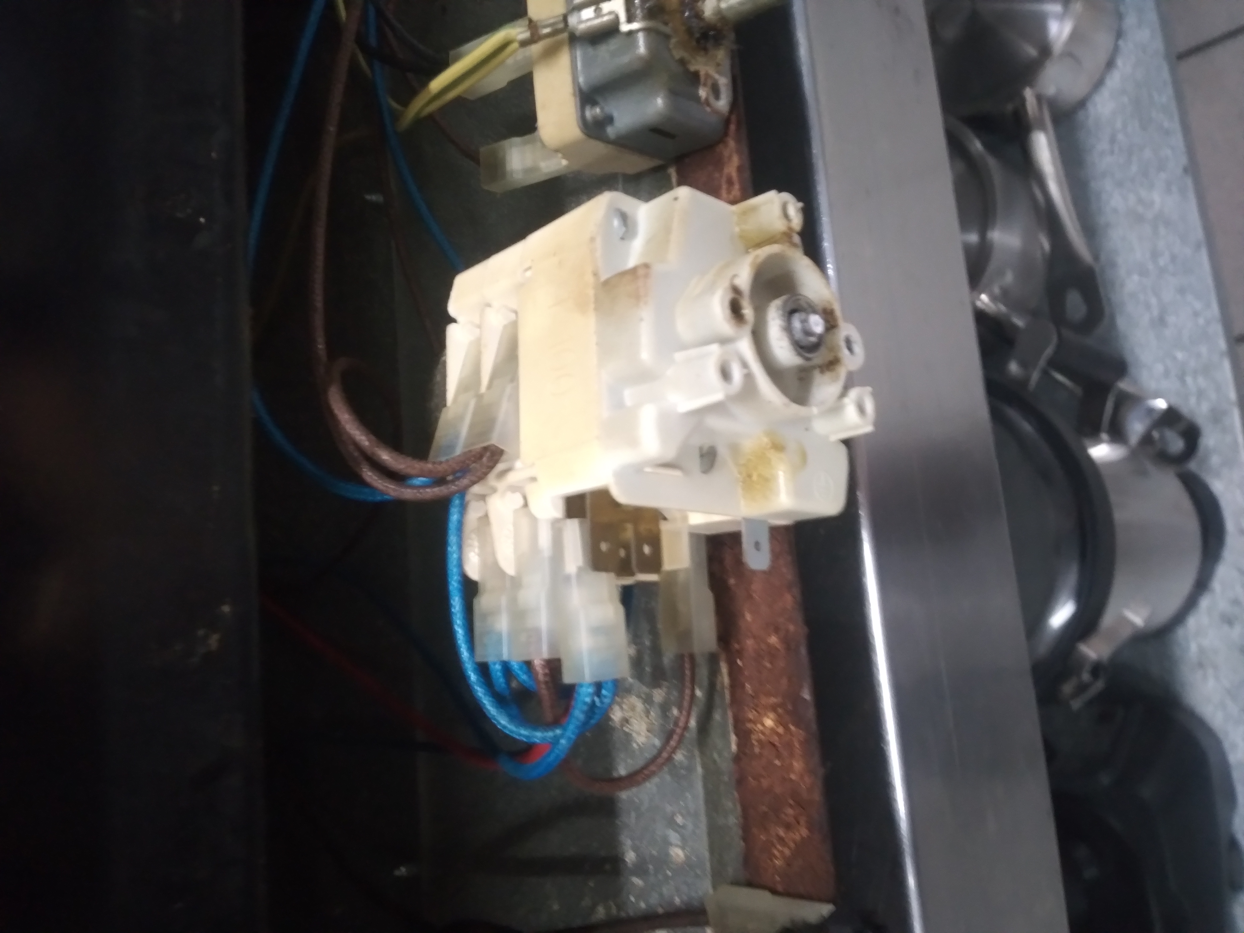 Heat-stressed commercial oven selector switch showing brittle plastic and control wiring