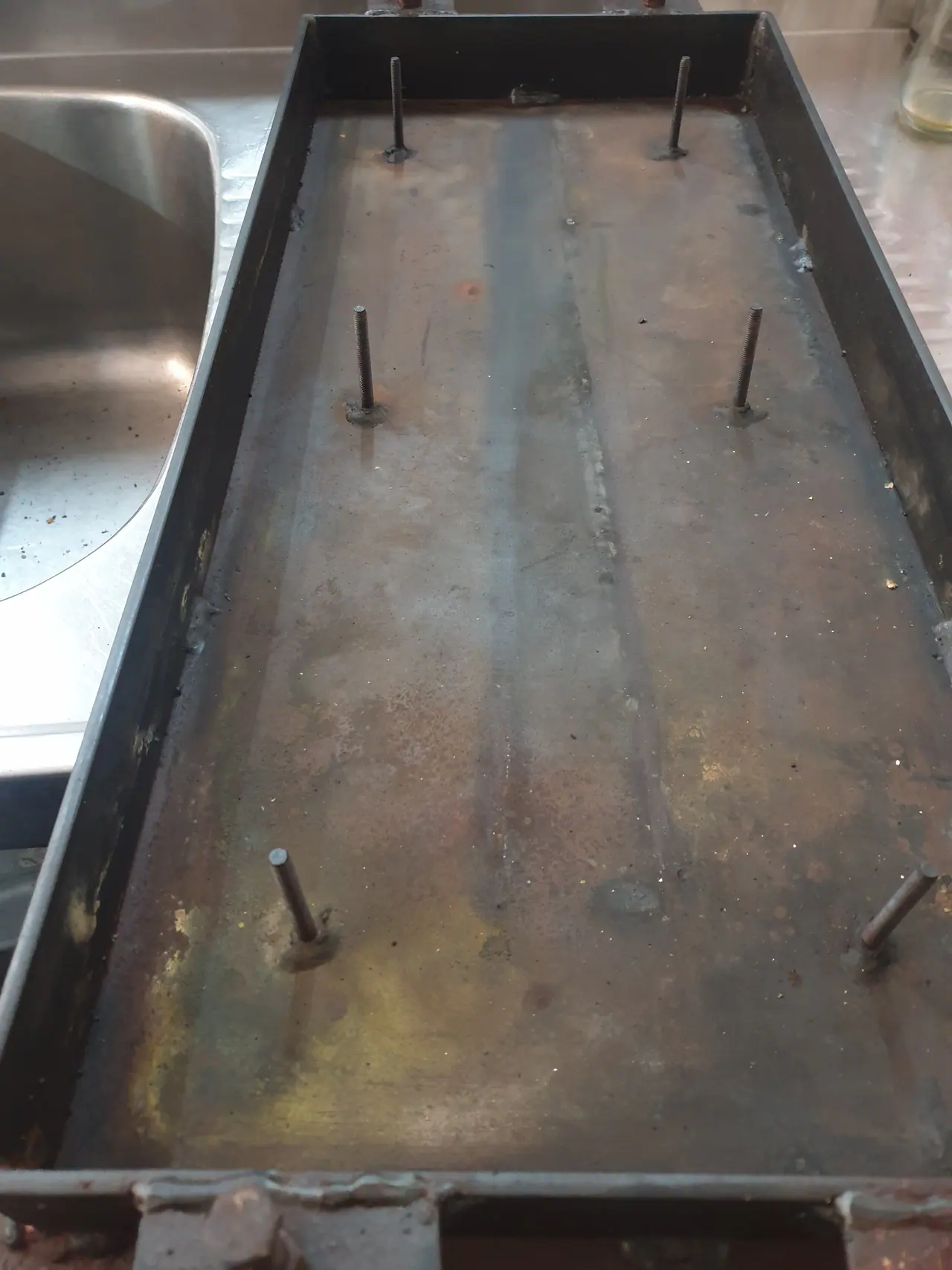 Commercial hotplate underside showing plate and mounting studs