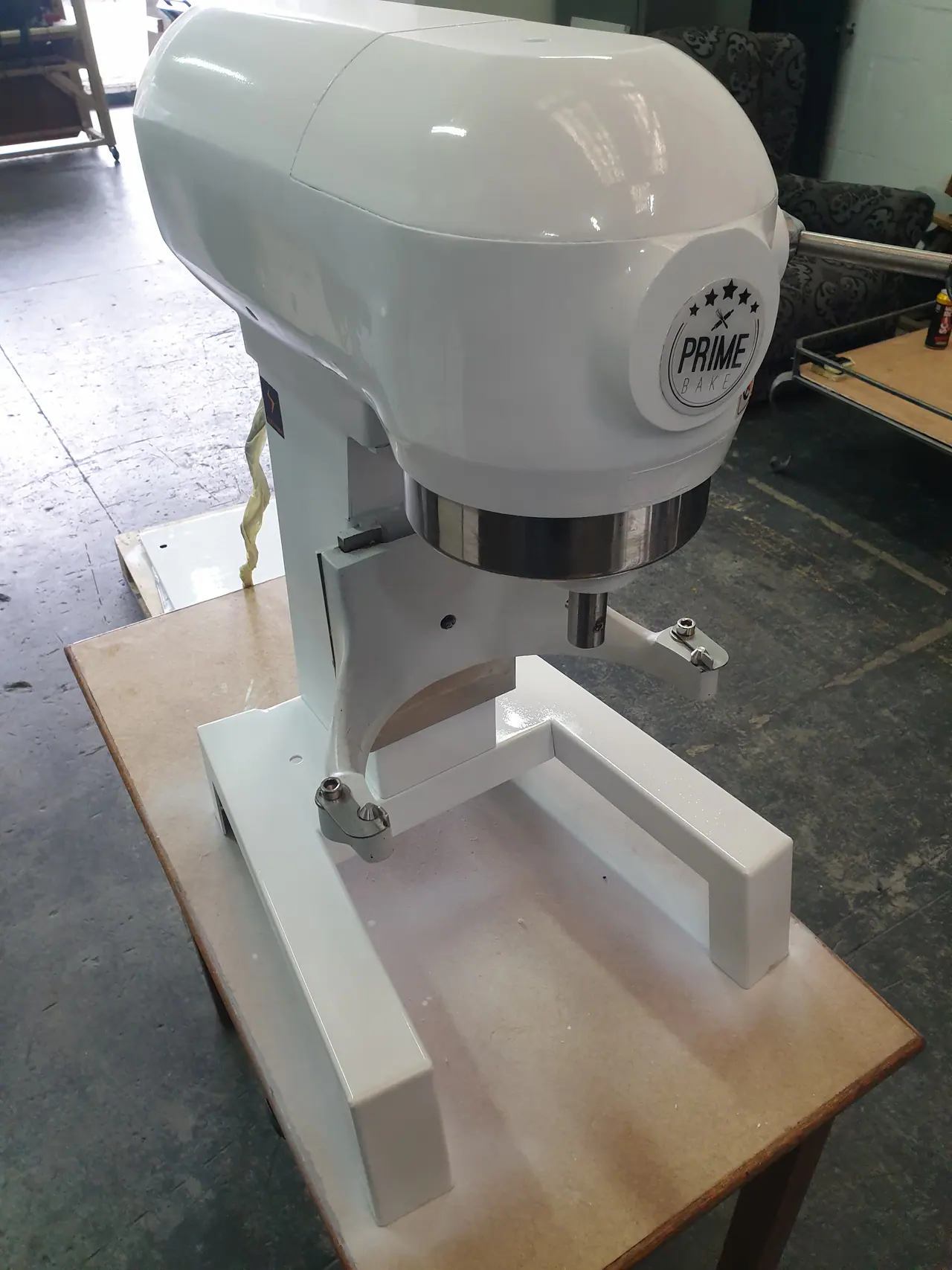Refurbished commercial mixer showing restored body finish and repaired mechanical assembly