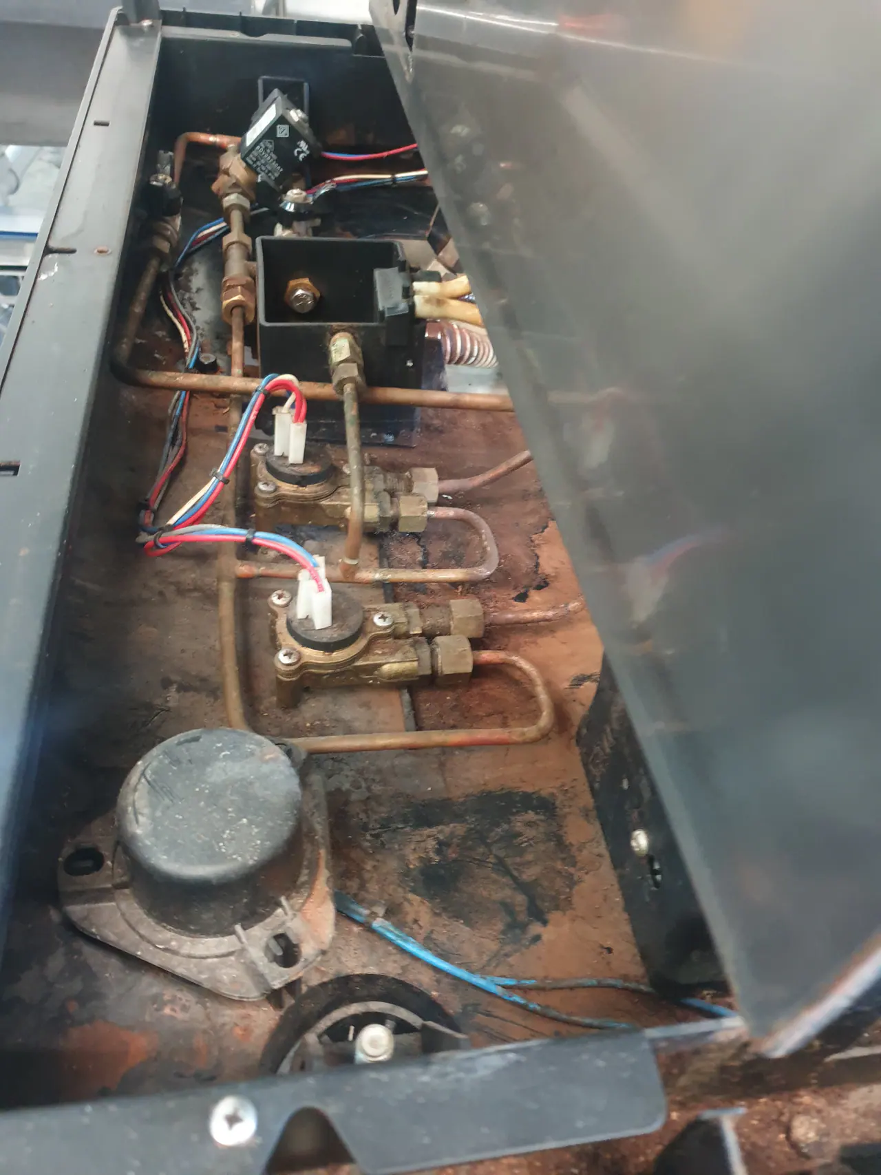Commercial coffee machine internals during solenoid and plumbing checks